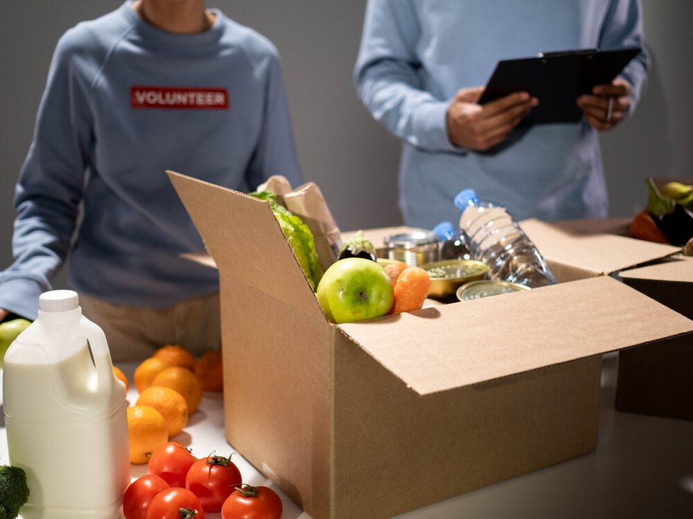 Volunteers packing and distributing boxes of food